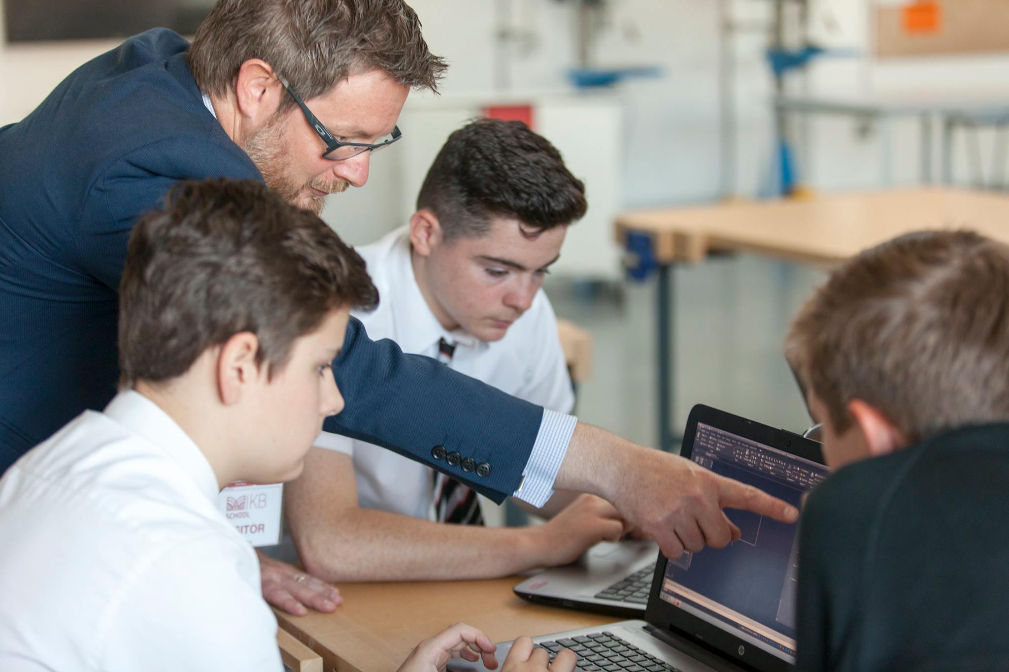 IKB students completing a computer-based engineering project with Jamie Siggers.